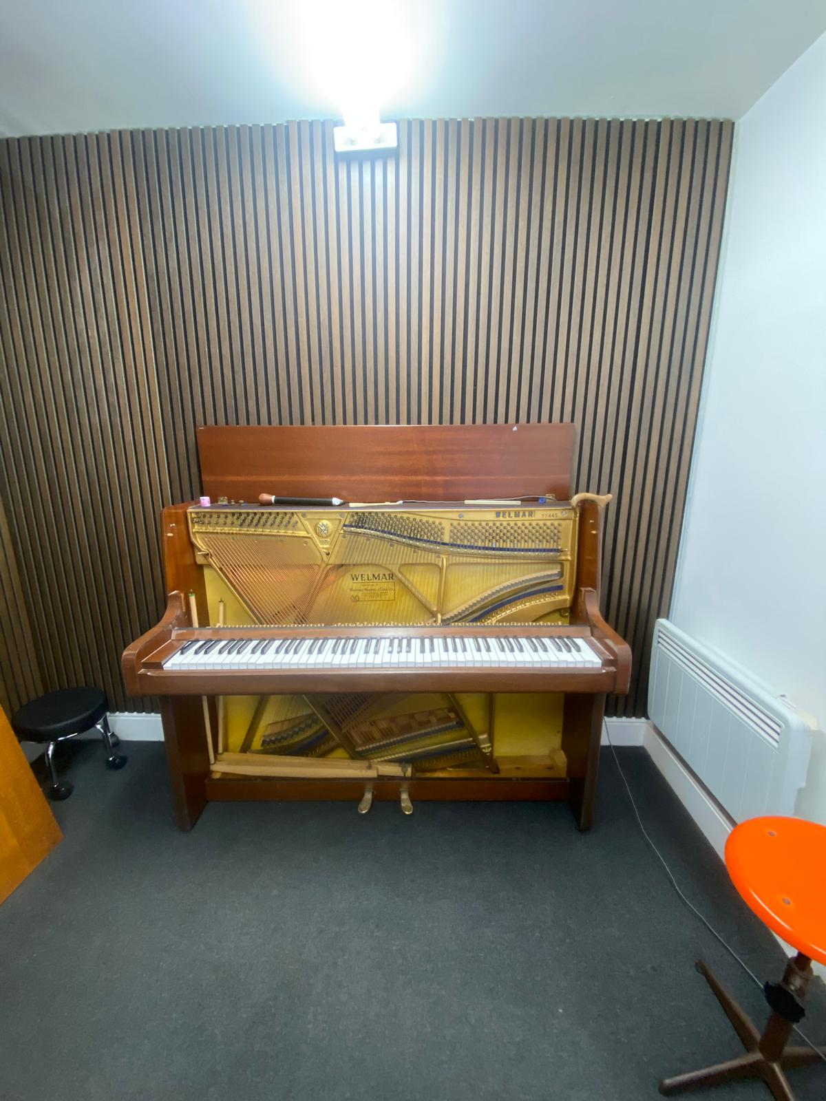 Welmar upright with the front panel removed, showing the action