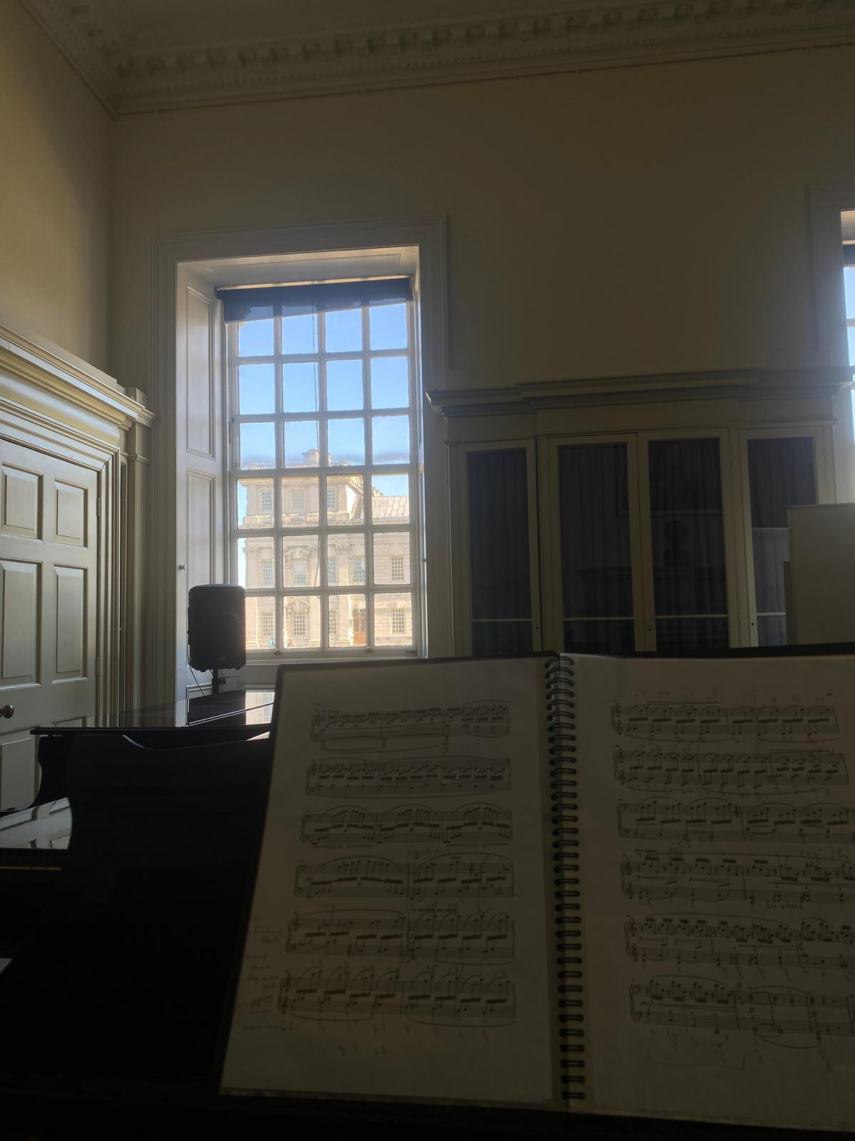 Sheet music on a grand piano at Trinity Laban, sunlit window beyond